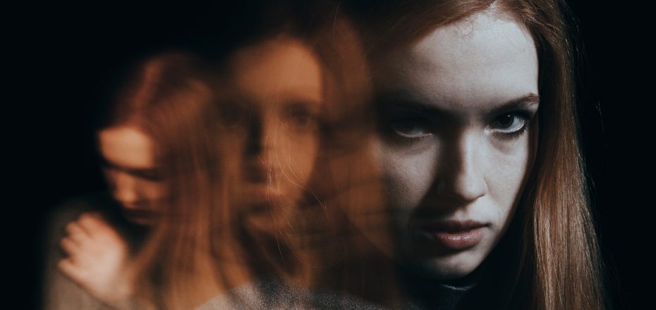 Blurred figures of red-haired girl
