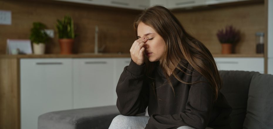 Caucasian woman with pain of nasal sinus at home
