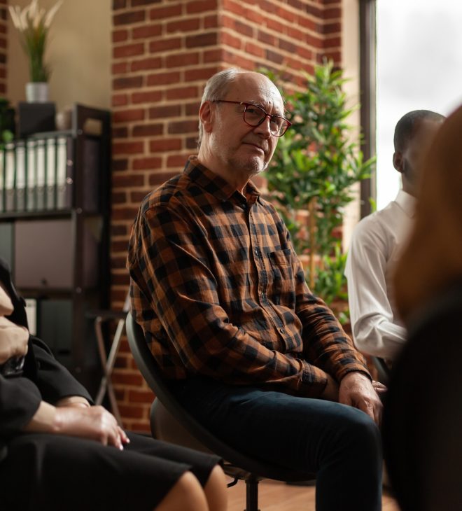 People talking to therapist at aa group therapy meeting, sharing addiction problems