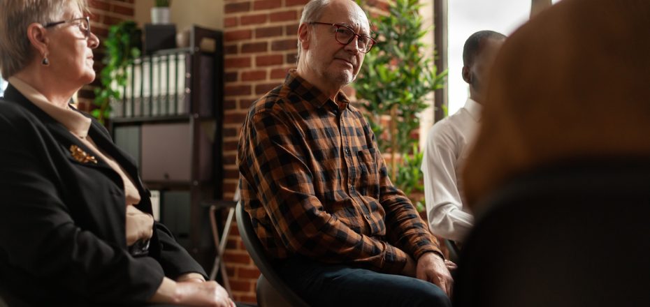 People talking to therapist at aa group therapy meeting, sharing addiction problems